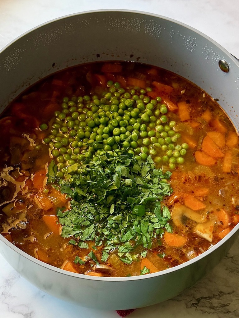 Peas and parsley added to the pot