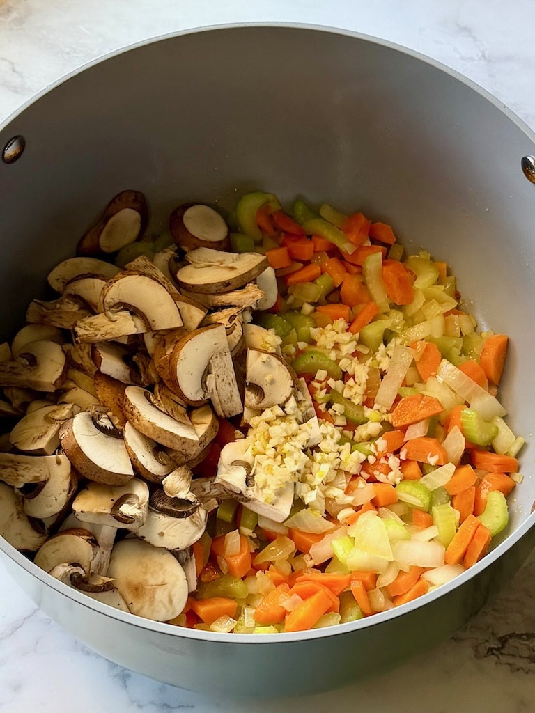 mushrooms and garlic added to the carrots and onions to sauté. 