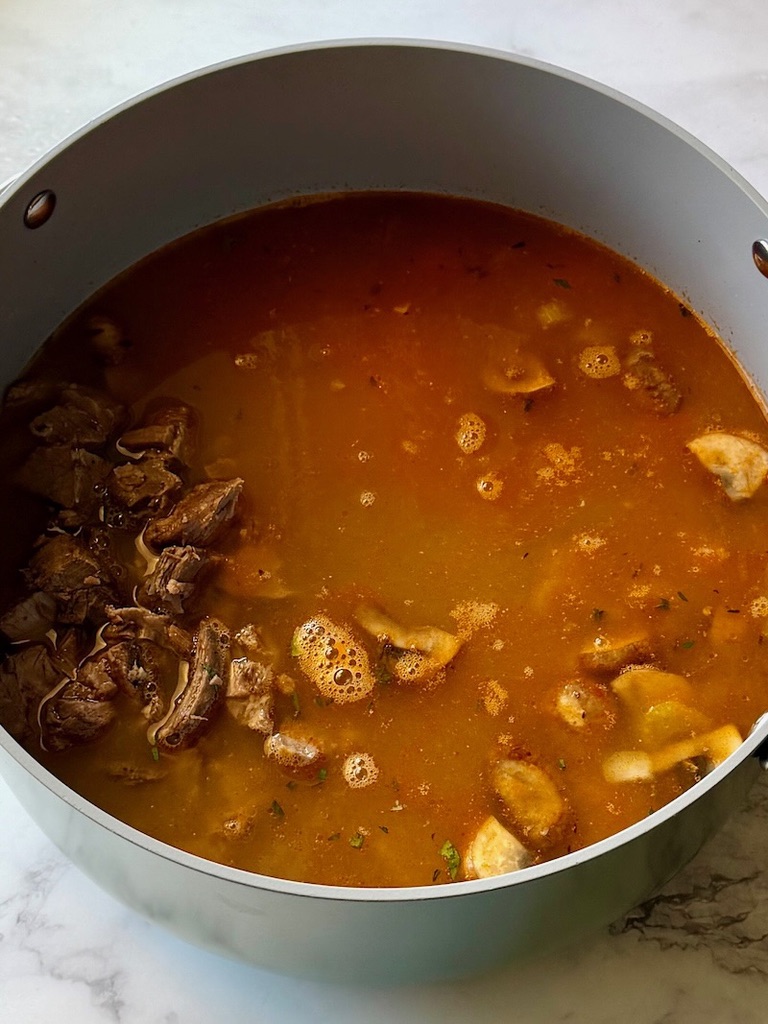 chicken broth, pot roast cooking liquid, and water added to the pot. 