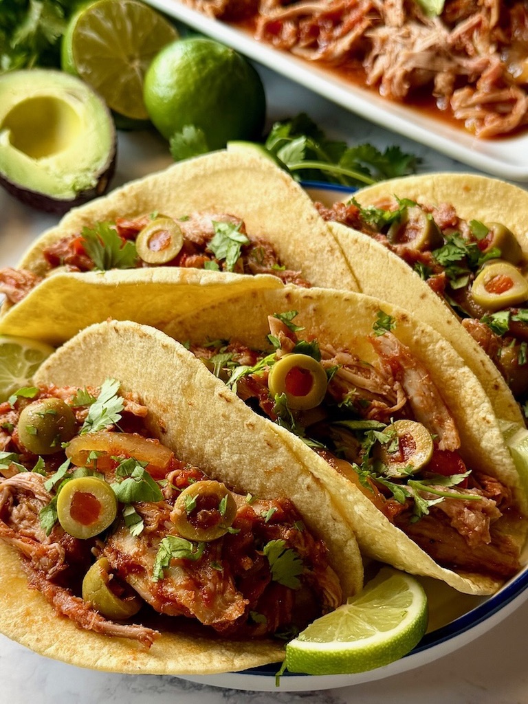 Spanish pulled pork in soft tacos.