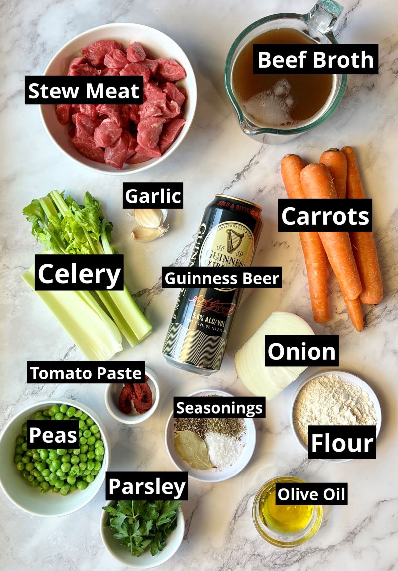 Ingredients for Irish Beef Stew Over Mashed Potatoes. Stew meat, beef broth, carrots, celery, garlic, onion, tomato paste, flour, Italian seasoning, salt, pepper, bay leaf, Guinness Beer, peas, parsely, olive oil