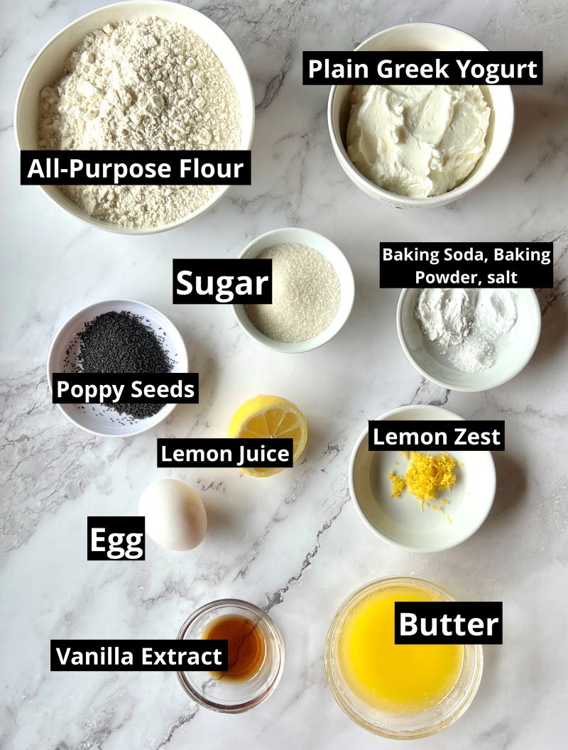 Ingredients for lemon poppy seed tea bread. All-purpose flour, sugar, baking soda, baking powder, salt, plain Greek yogurt, poppy seeds, lemon zest, lemon juice, egg, melted butter, vanilla extract. 