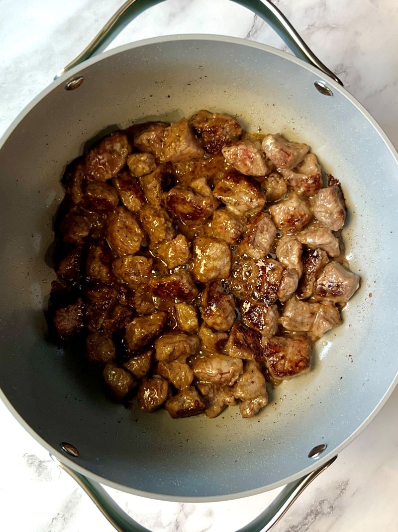 Beef chunks browned with olive oil in a large soup pot.