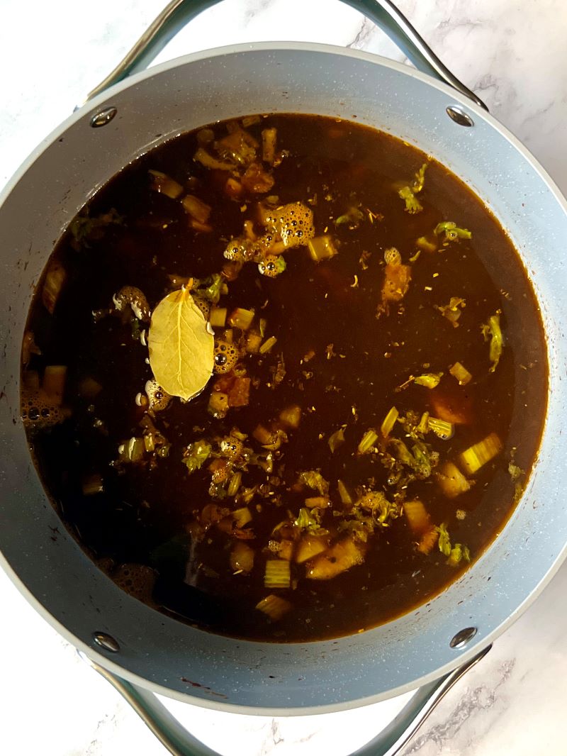 Beef, veggies, seasonings, broth and beer in a soup pot