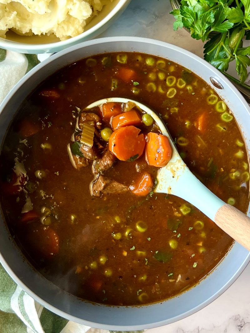 Pot of Irish stew with a ladle. 