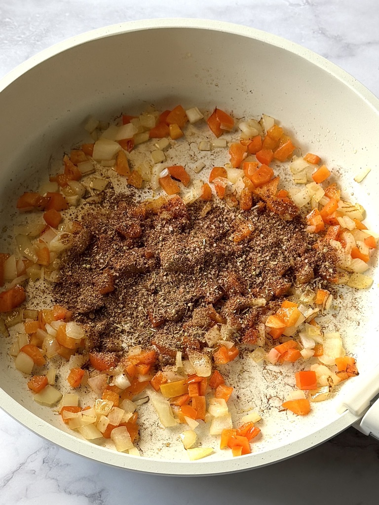Spices added to the bell peppers and onions