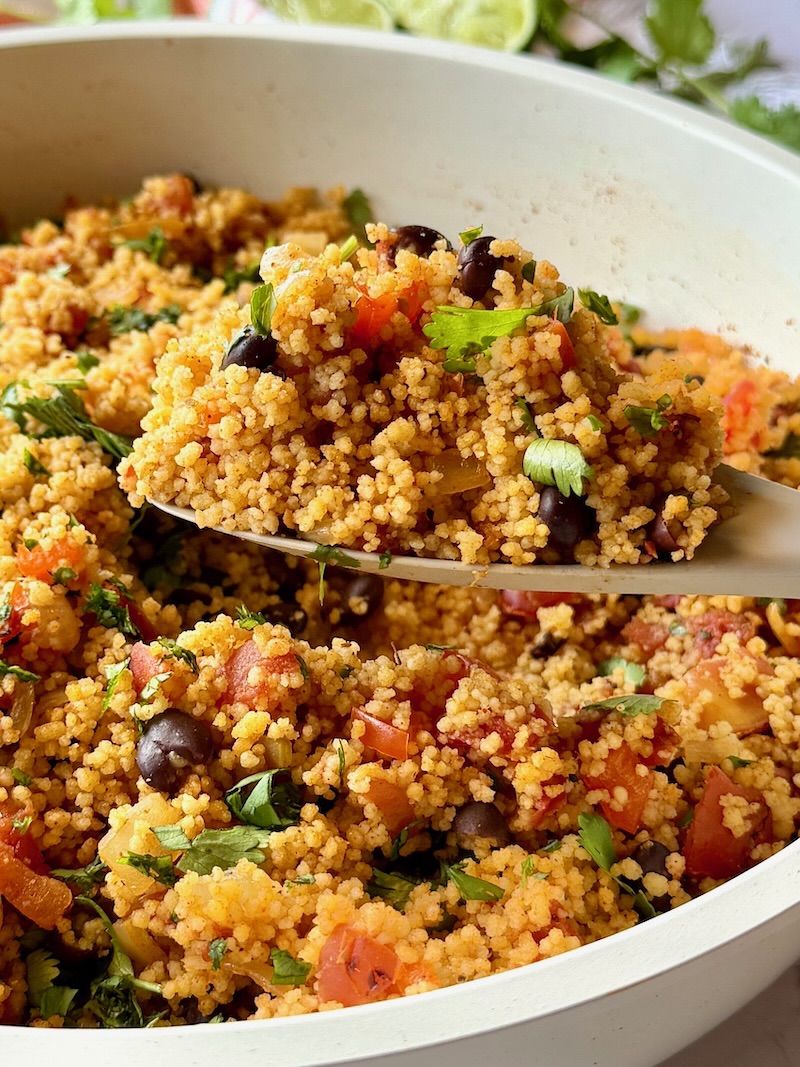 Mexican couscous with a serving spoon