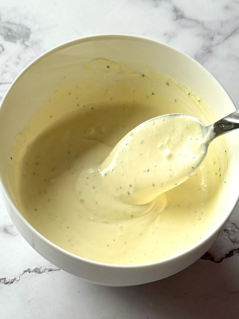 Dressing ingredients combined in a small bowl with a spoon
