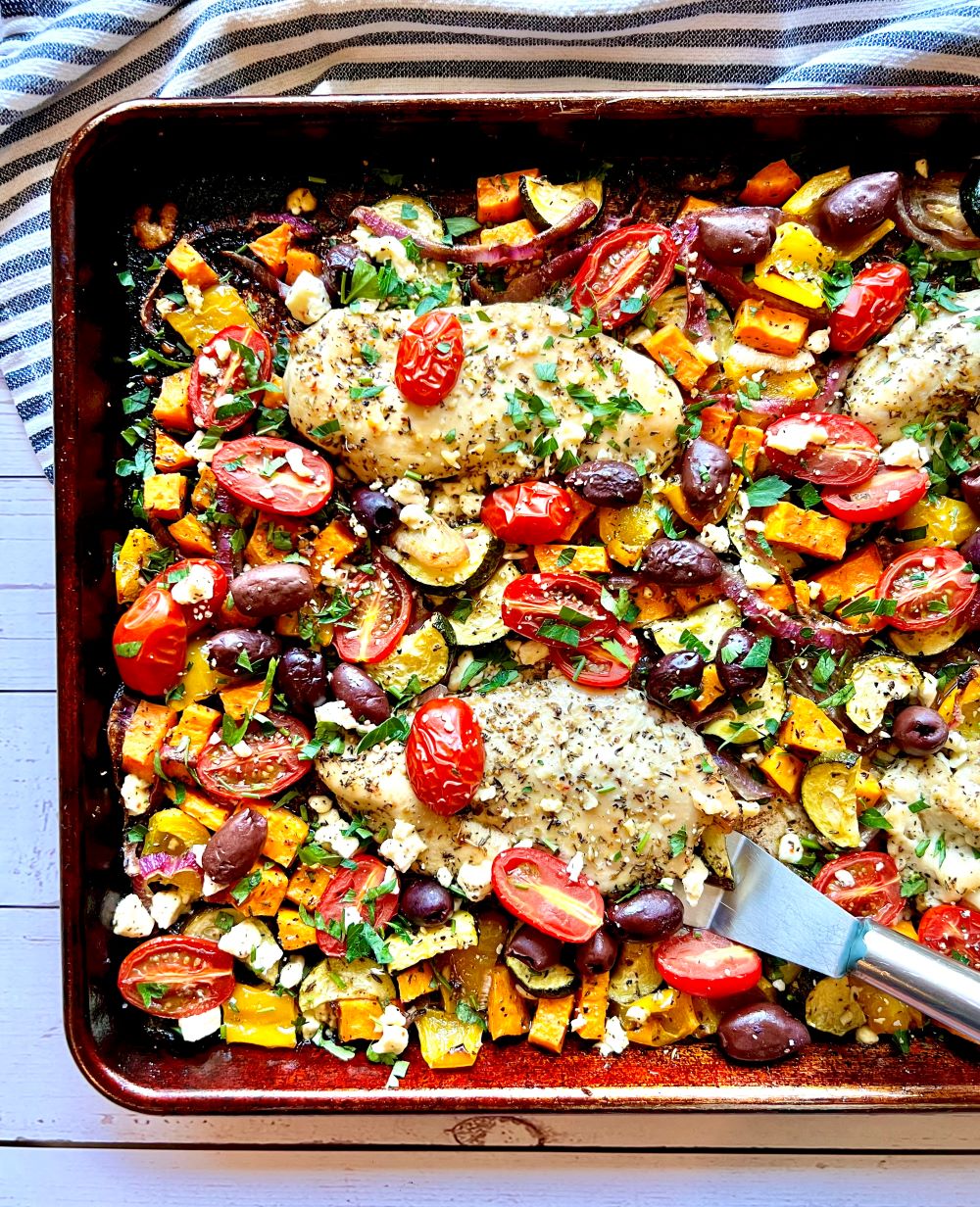 Sheet pan with roasted chicken and veggies.