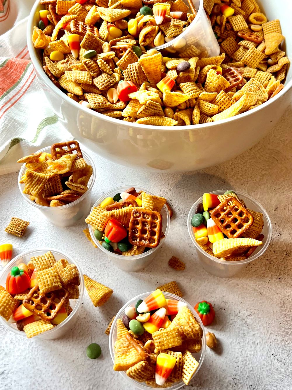 Chex mix set out in mini cups.