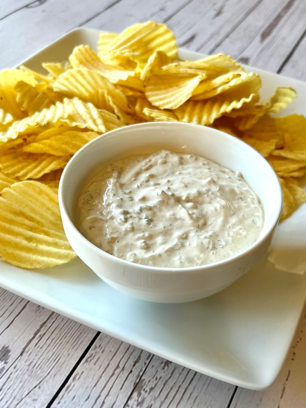 Plate with potato chips and onion dip