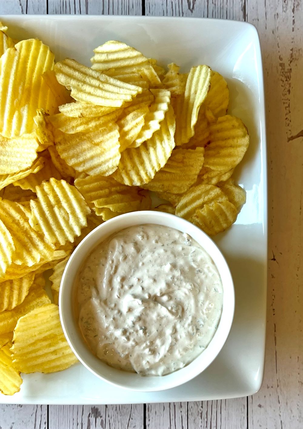 Plate with potato chips and onion dip