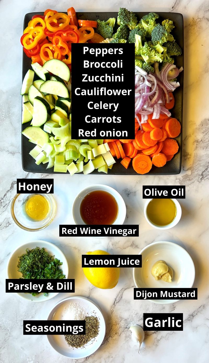 Ingredients for marinated vegetable salad. Bell peppers, broccoli, zucchini, cauliflower, celery, carrots, red onion, honey, olive oil, red wine vinegar, lemon juice, Dijon, garlic, fresh parsley and dill, Italian seasoning, salt and pepper.