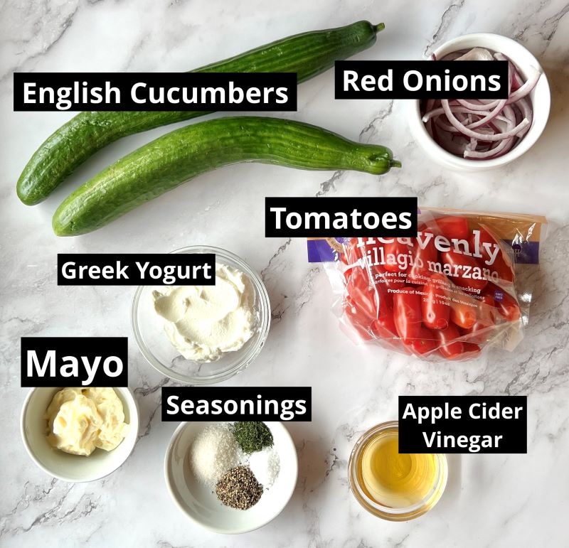 Ingredients for creamy cucumber tomato salad. Cucumbers, tomatoes, red onions, Greek yogurt, mayo, dried or fresh dill, sugar, salt, pepper, and apple cider vinegar.
