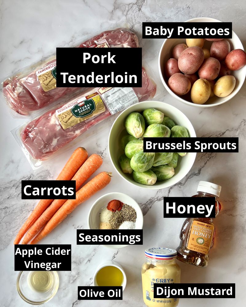 Ingredients for roasted pork tenderloin and vegetables. Pork tenderloin, baby potatoes, brussels sprouts, carrots, honey, Dijon mustard, olive oil, apple cider vinegar, garlic powder, smoked paprika, onion powder, Italian seasoning, salt, and pepper.