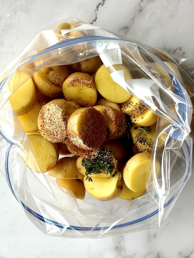 Seasoned potatoes in a zip lock bag.