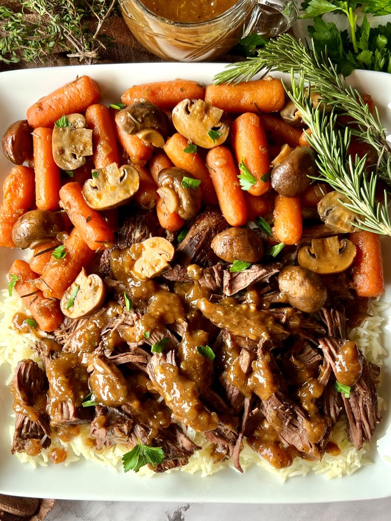 Braised pot roast with mushrooms served over rice and topped with gravy. 