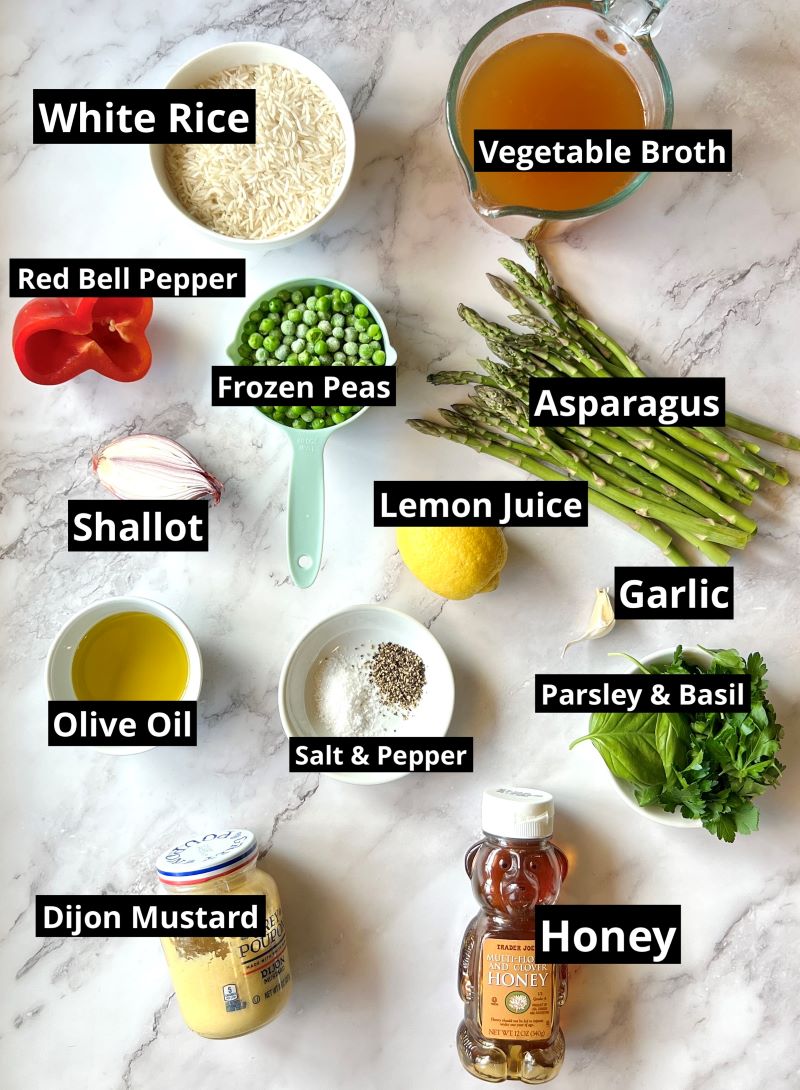 Ingredients for spring rice salad with lemon dressing. White rice, vegetable broth, shallots, lemon zest, lemon juice, asparagus, peas, red bell pepper, garlic, olive oil, parsley, basil, salt, pepper, honey, Dijon mustard.