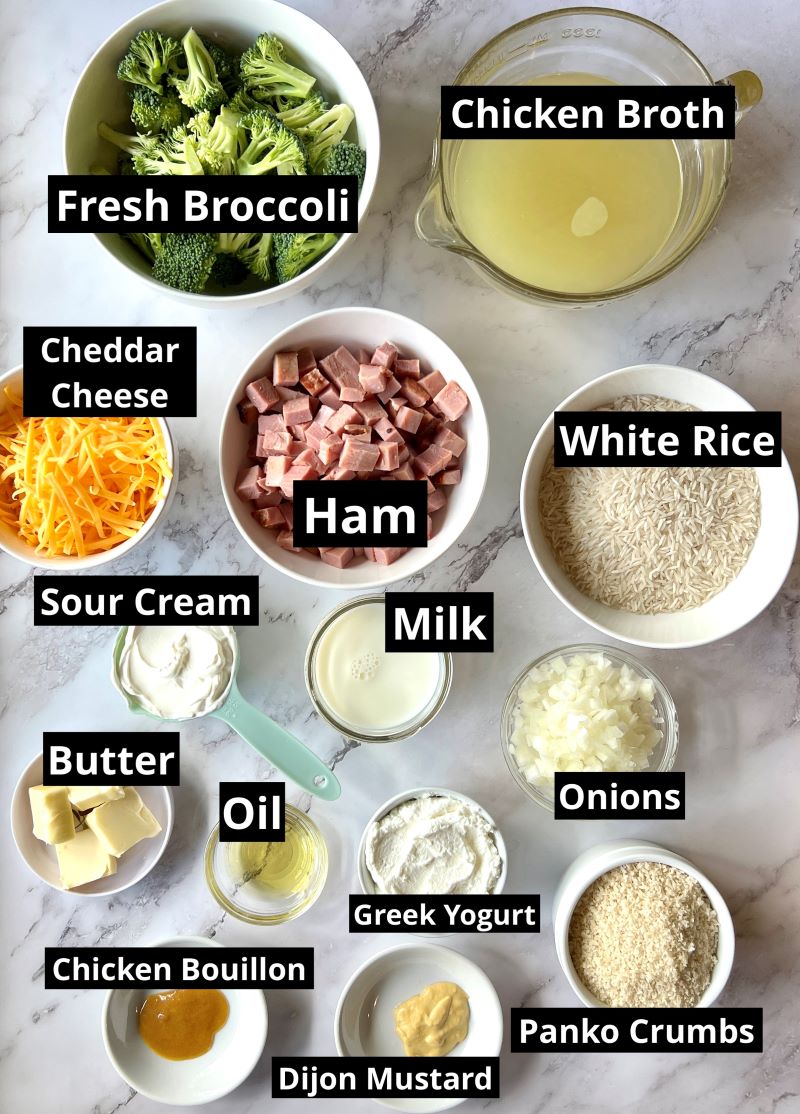 Ingredients for ham and broccoli Rice casserole. fresh broccoli, ham, white rice, chicken broth, cheese, sour cream, onions, milk, Greek yogurt, chicken bouillon, oil, butter, Dijon mustard, salt and pepper, panko bread crumbs. 