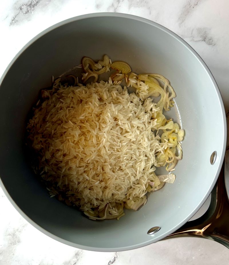 Shallots and rice sautéed with olive oil.