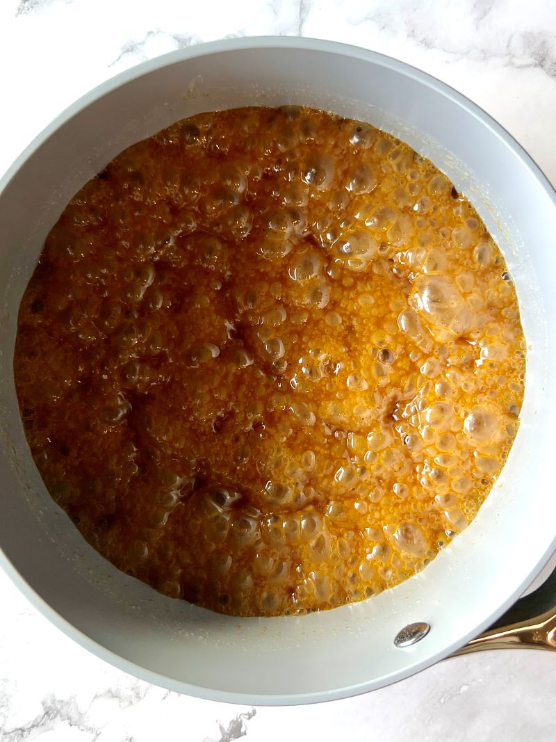 sweet and spicy glaze ingredients combined in a small saucepan. Butter, brown sugar, corn syrup, and spices. 