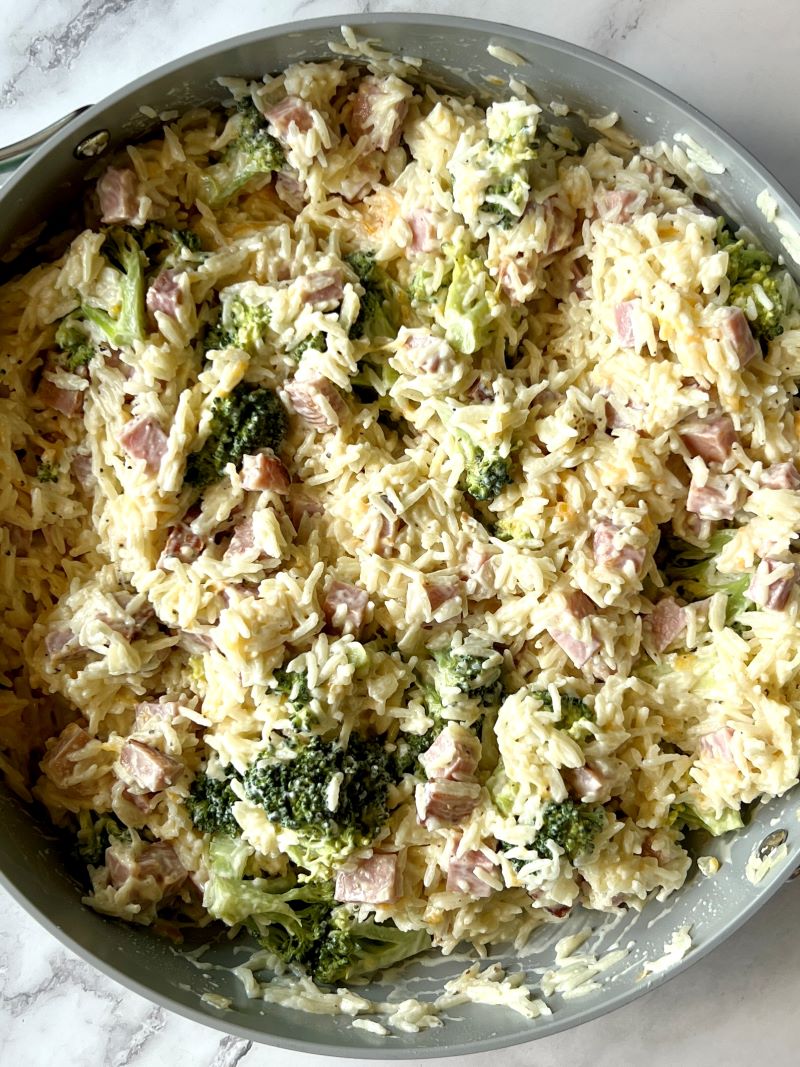 Cooked rice with broccoli, ham, cheese, homemade cream sauce, sour cream and milk. 