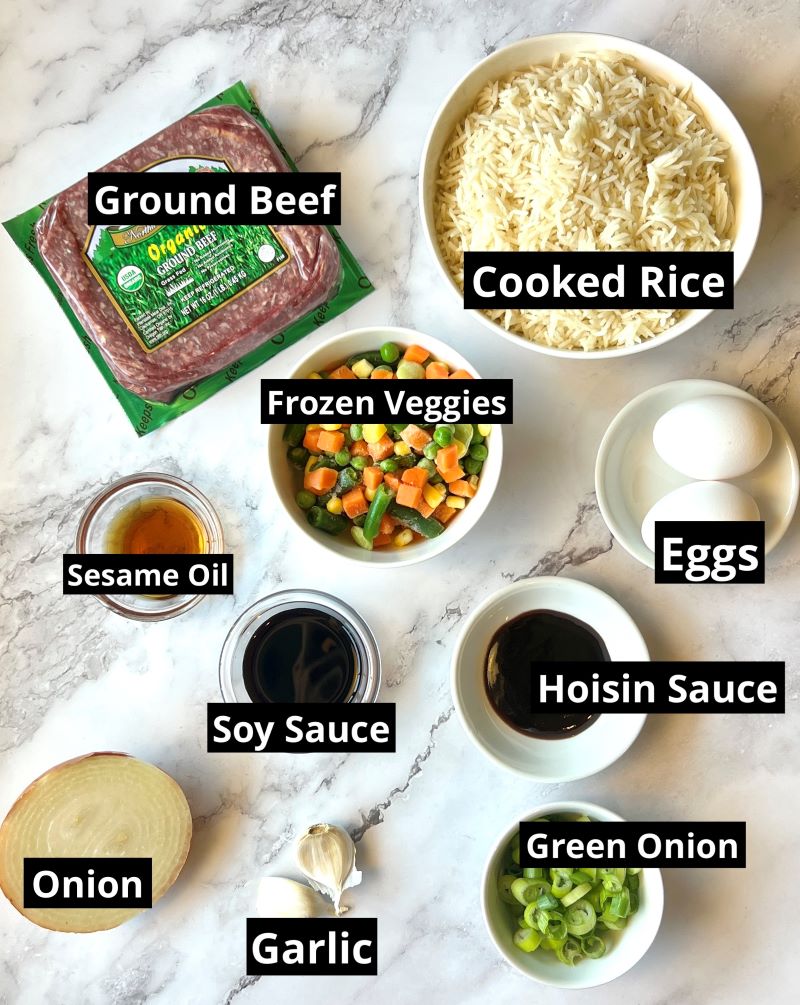 Ingredients for ground beef fried rice. Ground beef, cooked white rice, frozen veggies, eggs, sesame oil, hoisin sauce, soy sauce, onion, garlic, green onions.