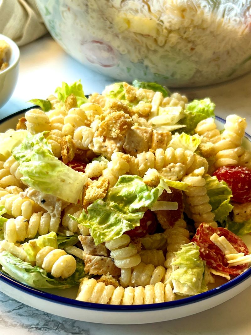 Chicken Caesar pasta salad plated on a small plate. 