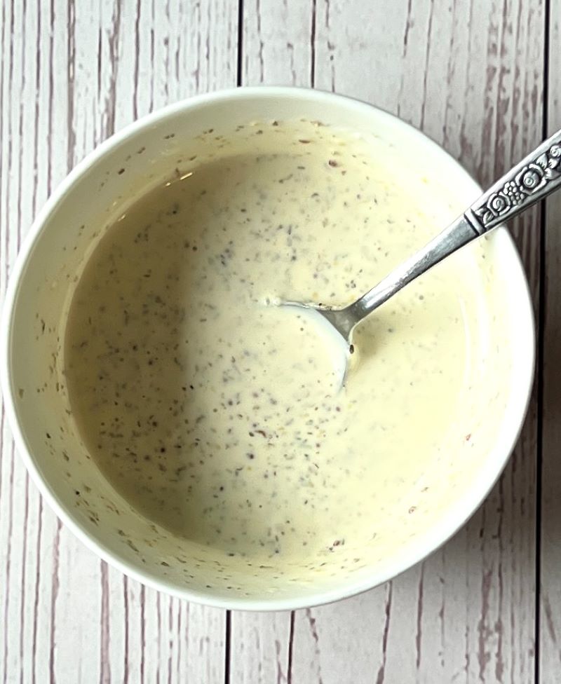 Dressing prepared in a small bowl for Italian chopped salad hoagie rolls.