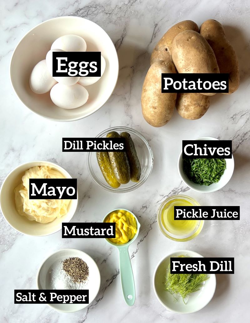 Ingredients displayed for mom's famous potato salad. Eggs, russet potatoes, dill pickles, chives, pickle juice, mayo, mustard, fresh dill, salt and pepper. 