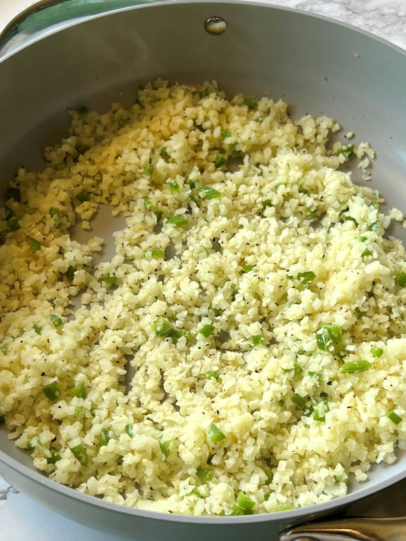 Cauliflower rice cooked in a skillet.