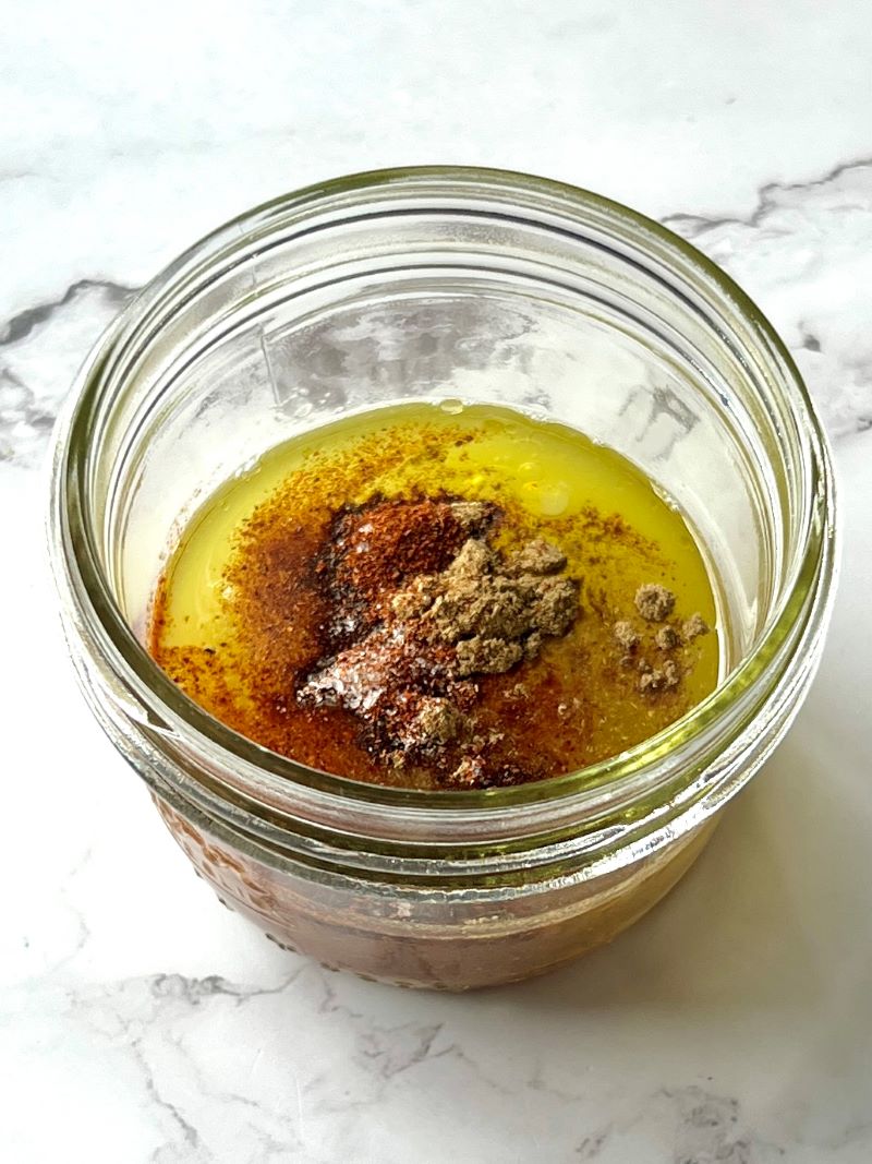 Dressing ingredients in a small mason jar.