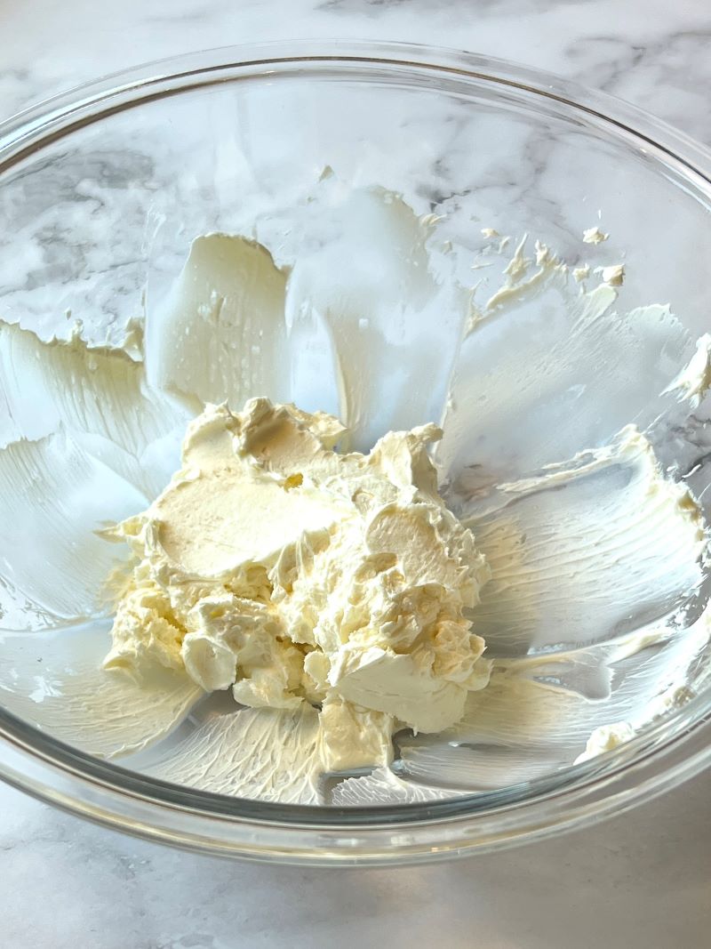 Cream cheese whipped in a medium bowl.