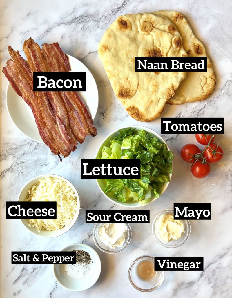 Ingredients for grilled BLT flatbread. Cooked bacon, Naan bread, tomatoes, lettuce, sour cream, mayo, red wine vinegar, mozzarella cheese, salt and pepper.