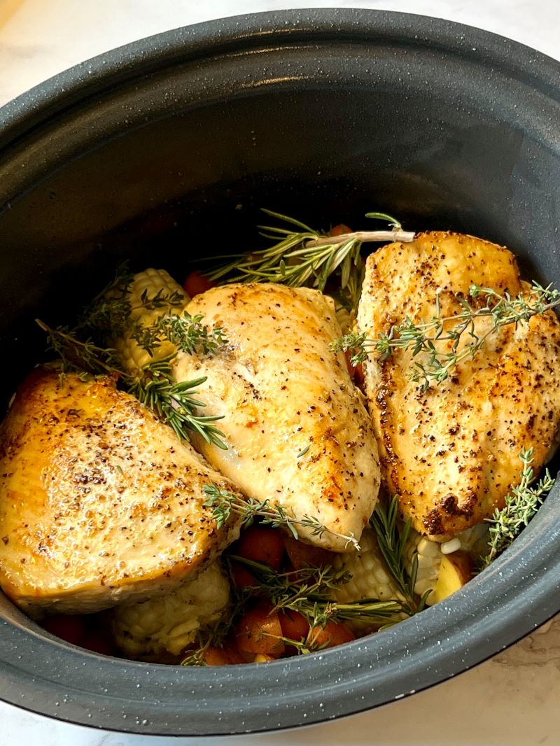 Veggies layered with seared chicken and topped with fresh rosemary and thyme. 