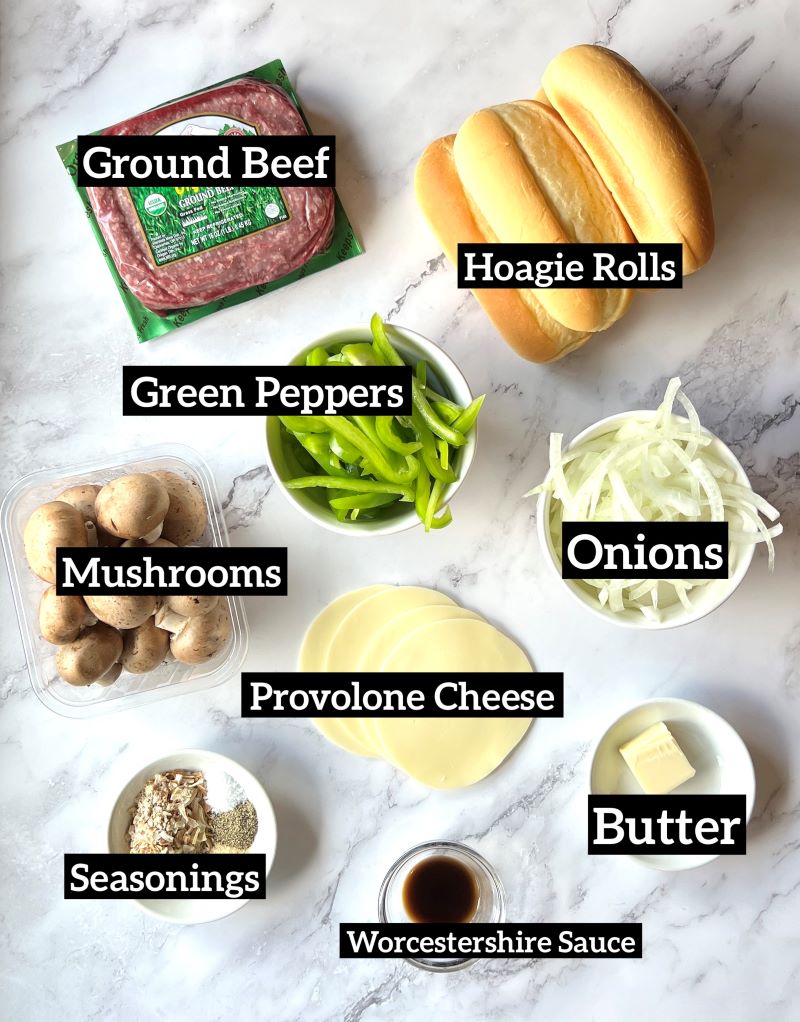 Ingredients displayed for ground beef Philly cheesesteaks. Ground beef, Hawaiian hoagie rolls, green bell peppers, onions, mushrooms, seasonings, provolone cheese, butter, and Worcestershire sauce. 