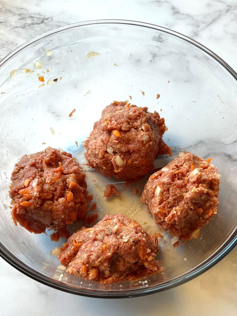Meatloaf divided into 4 portions in a bowl