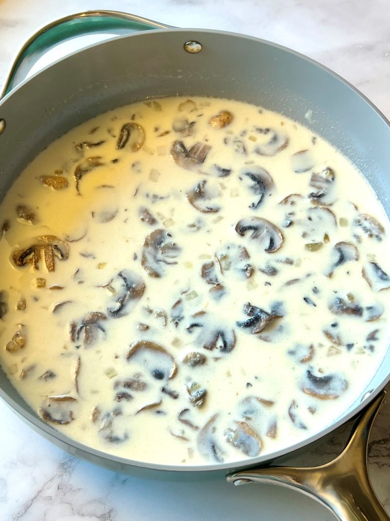 Flour, milk, broth, and seasonings added to the sautéed veggies. 