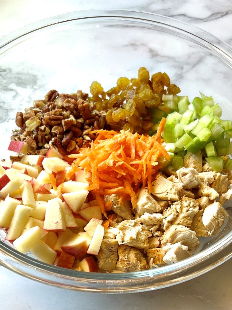 Harvest chicken salad ingredients in a medium bowl.