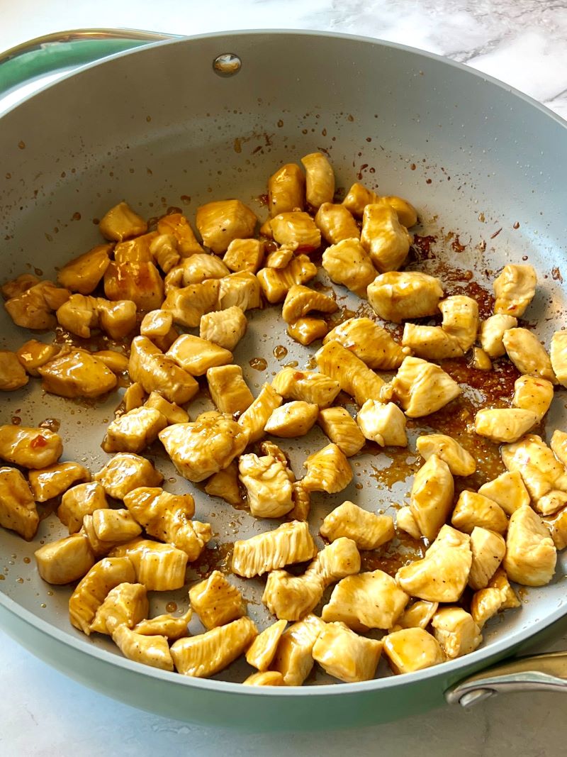 Marinated chicken cooked in a skillet.
