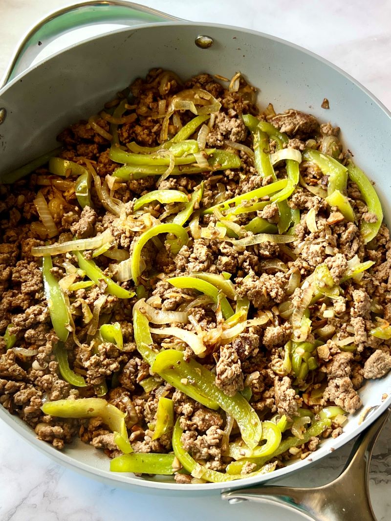 Ground beef and veggies combined with seasonings and Worcestershire in the skillet. 