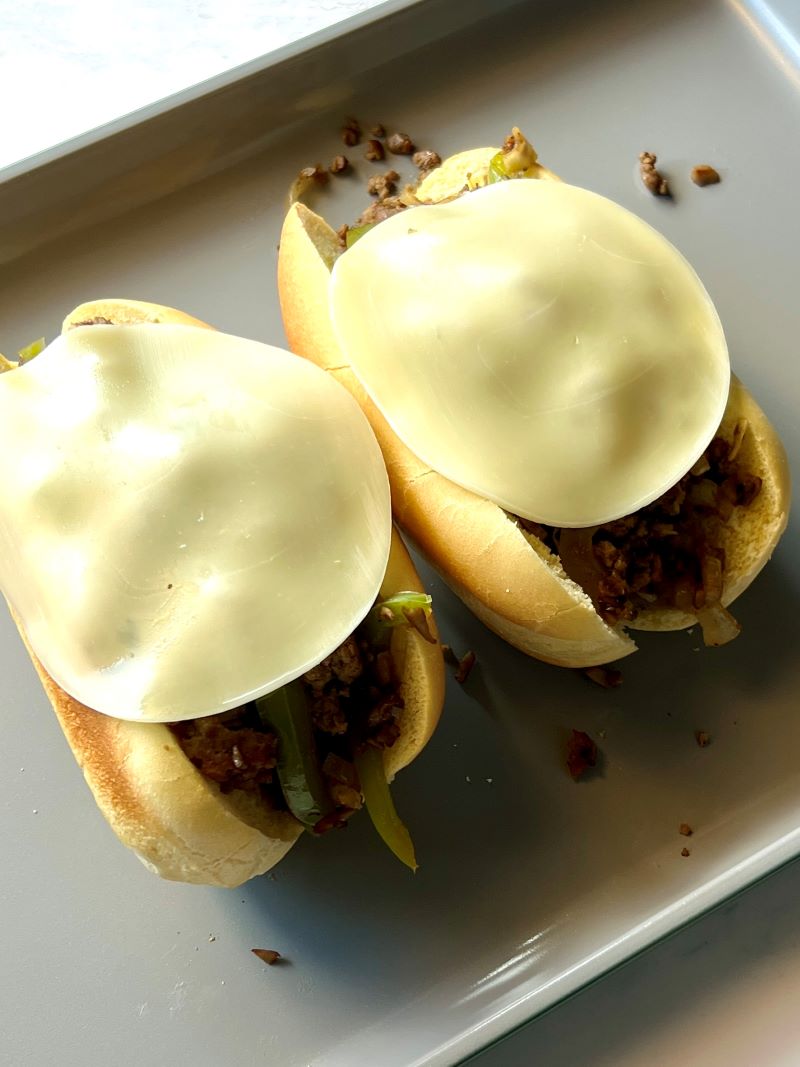 Meat mixture added to hoagie rolls and topped with provolone cheese to broil. 