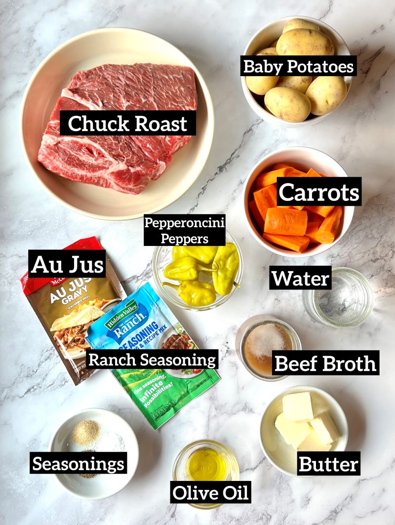 Ingredients displayed for Mississippi pot roast (small family). Chuck roast, baby potatoes, carrots, pepperoncini peppers, pepperoncini juice, water, beef broth, Au jus gravy mix, ranch seasoning mix, butter, garlic powder, salt, pepper, and olive oil. 