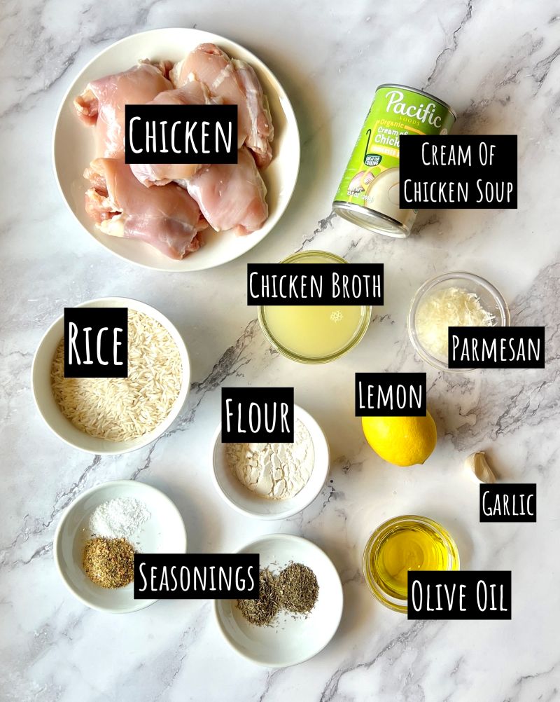 Ingredients displayed for creamy lemon chicken rice casserole. Chicken thighs, creamy of chicken soup, chicken broth, parmesan cheese, white rice, flour, lemon, garlic, olive oil, seasonings.
