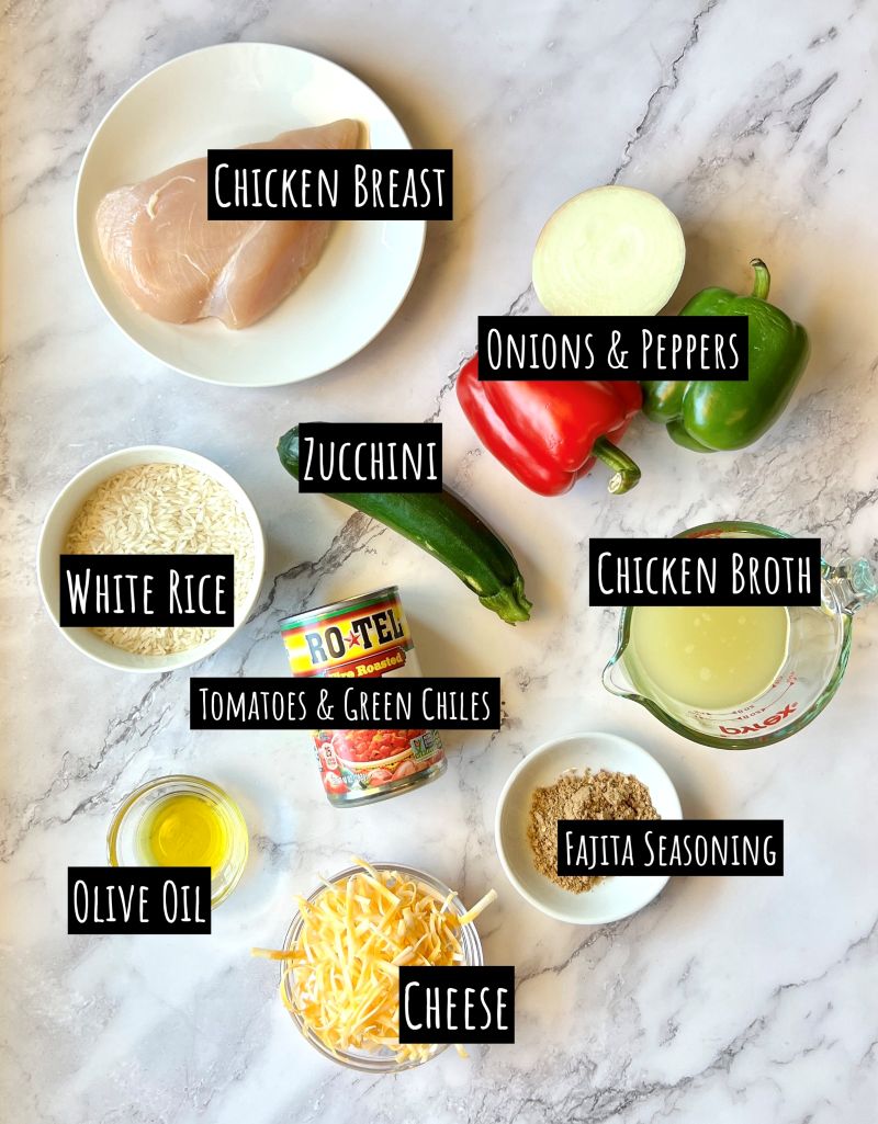 Ingredients displayed for Easy chicken fajita Casserole. Chicken breast, onions, peppers, zucchini, white rice, chicken broth, tomatoes and green chiles, fajita seasoning, olive oil, and shredded cheese. 