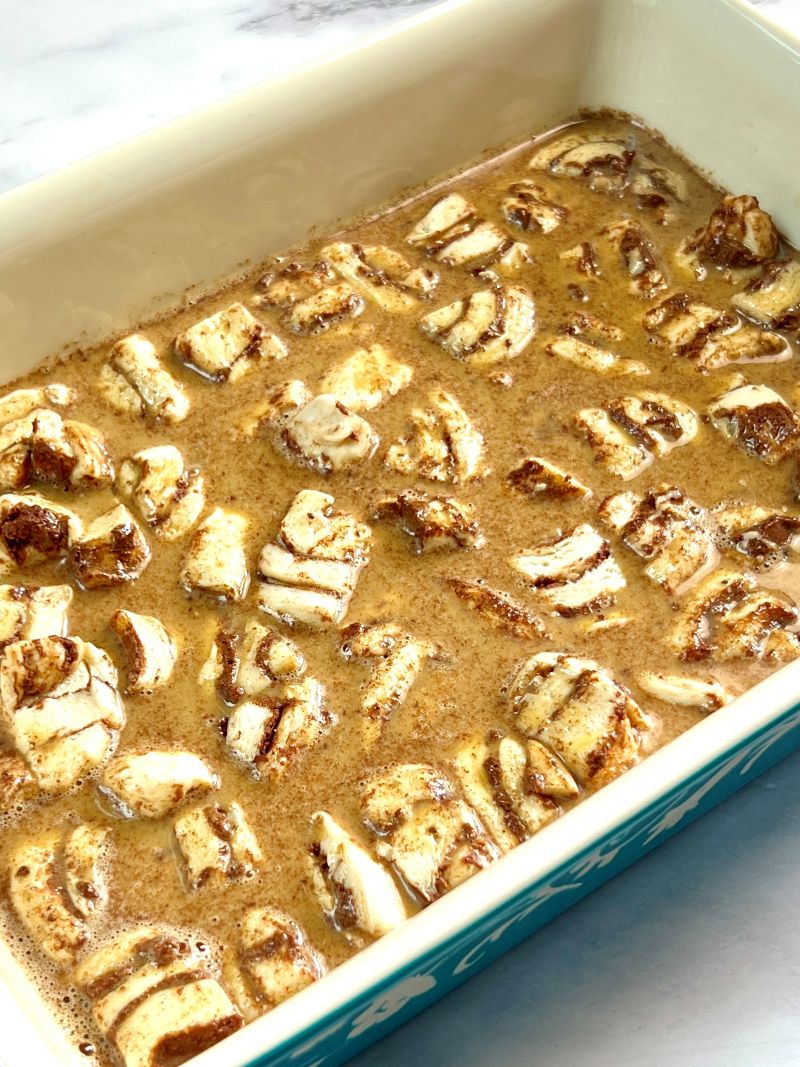 Egg mixture poured over cinnamon roll pieces. 