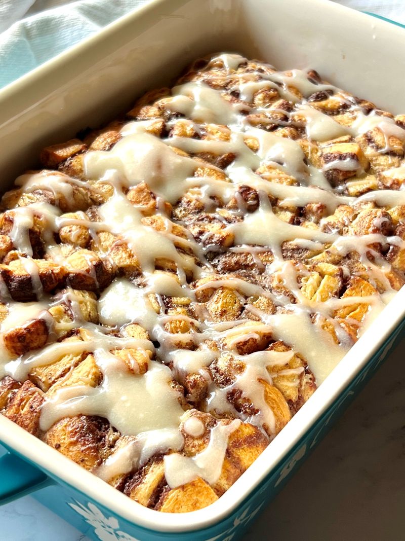 Icing drizzled over baked cinnamon rolls. 