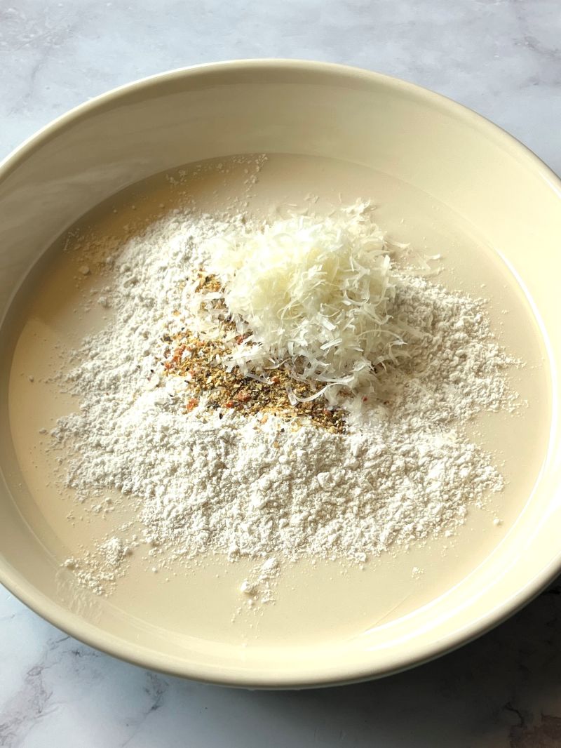 Light flour coating in a bowl for the chicken.