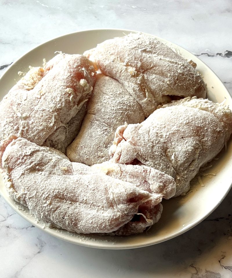 Boneless skinless chicken thighs coated with flour, parmesan cheese, lemon pepper and salt.