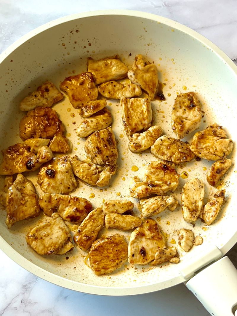 Chicken pieces browned in a small skillet with fajita seasoning.